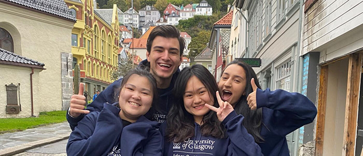 Four students standing in Bergen, Norway, having a group photograph taken